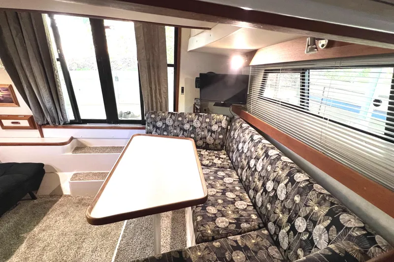Slide: The Image of Interior of 1989 Carver 32 Mariner with patterned seating and dining table. - 18