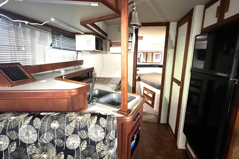 Slide: The Image of Interior of 1989 Carver 32 Mariner yacht with kitchen and sleeping area. - 24