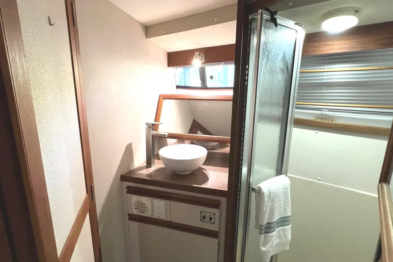 Slide: The Image of 1989 Carver 32 Mariner bathroom with modern sink, mirror, and towel rack. - 27