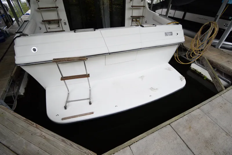 Slide: The Image of 1989 Carver 32 Mariner boat stern with swim platform and ladder in dock. - 30