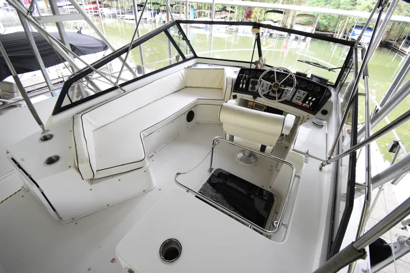 Slide: The Image of 1989 Carver 32 Mariner boat cockpit with white seating and control panel. - 9