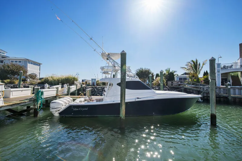 Slide: The Image of 2017 Jupiter 41SB boat docked at a marina under a bright sun. - 0