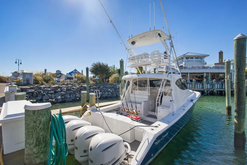 Slide: The Image of 2017 Jupiter 41SB boat docked at marina with triple Yamaha engines. - 3