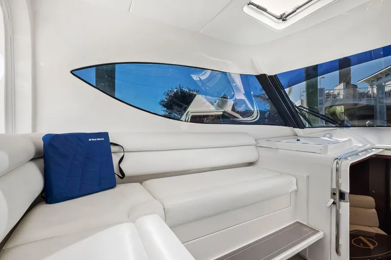 Slide: The Image of Interior of 2017 Jupiter 41SB boat with white seating and large windows. - 9