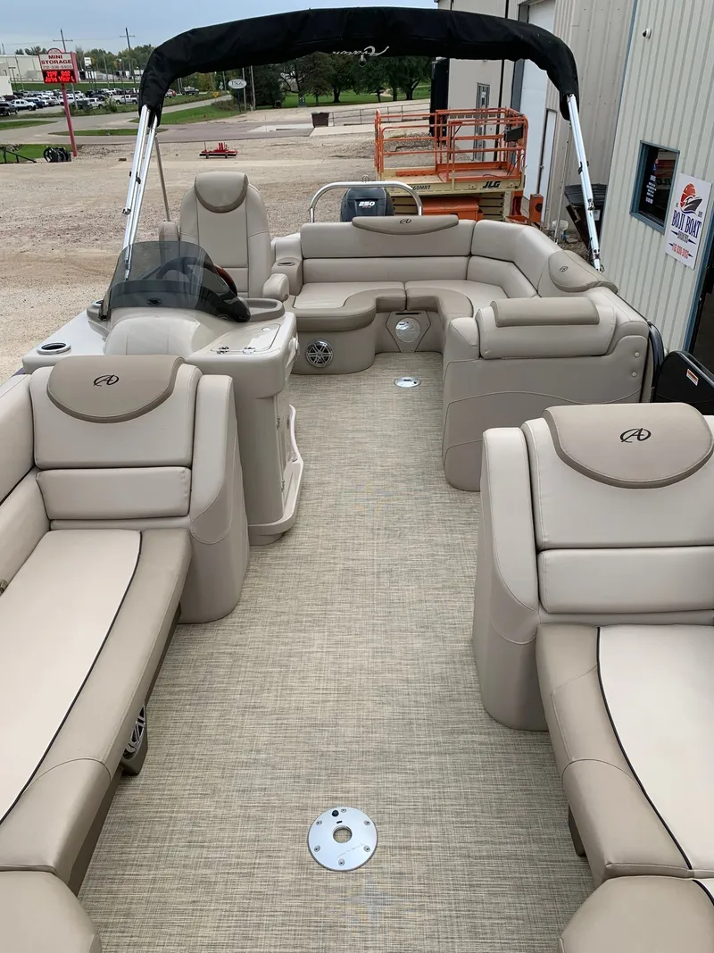 Slide: The Image of 2015 Avalon Ambassador Rear J Lounge 25' pontoon boat with beige seating and canopy. - 13