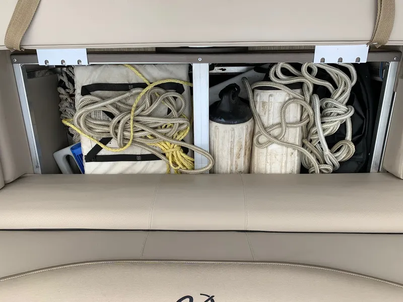 Slide: The Image of Storage compartment in 2015 Avalon Ambassador boat with ropes and fenders. - 14