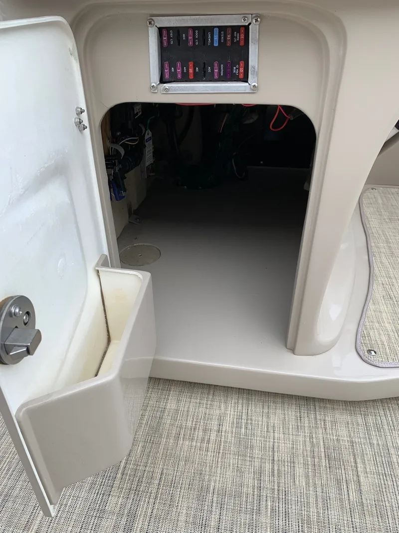 Slide: The Image of Open storage compartment in 2015 Avalon Ambassador Rear J Lounge boat. - 17