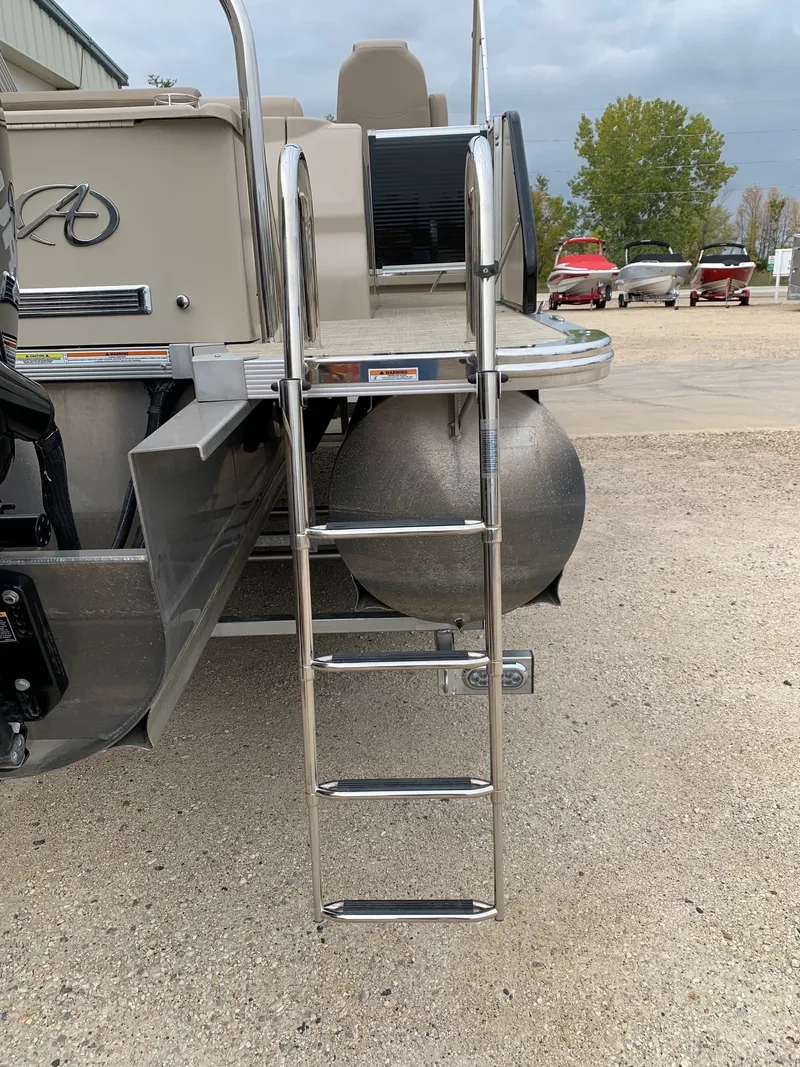 Slide: The Image of 2015 Avalon Ambassador Rear J Lounge boat with ladder and pontoons. - 8