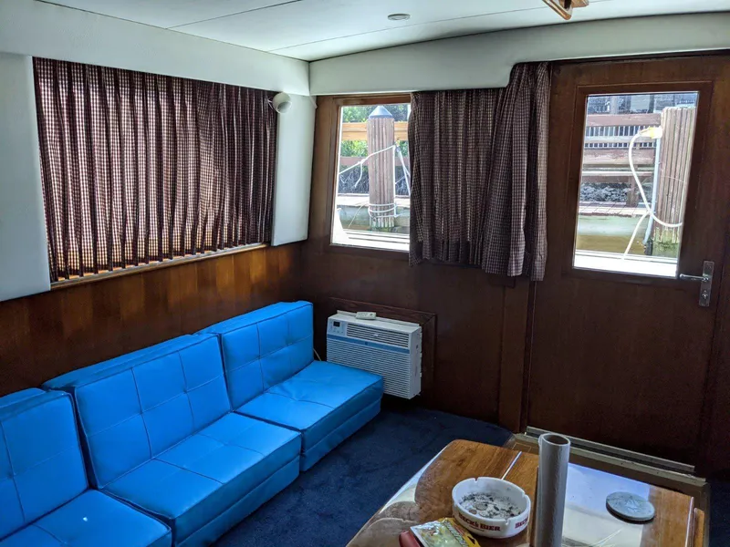 Slide: The Image of Interior of 1977 Hatteras 46 Convertible with blue seating and wood paneling. - 11