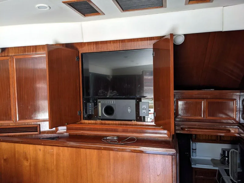 Slide: The Image of 1977 Hatteras 46 Convertible interior with wooden cabinetry and built-in electronics. - 13