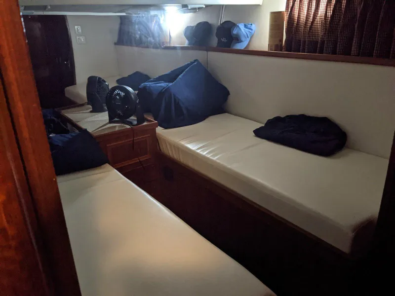 Slide: The Image of 1977 Hatteras 46 Convertible cabin with twin beds and cozy interior. - 18