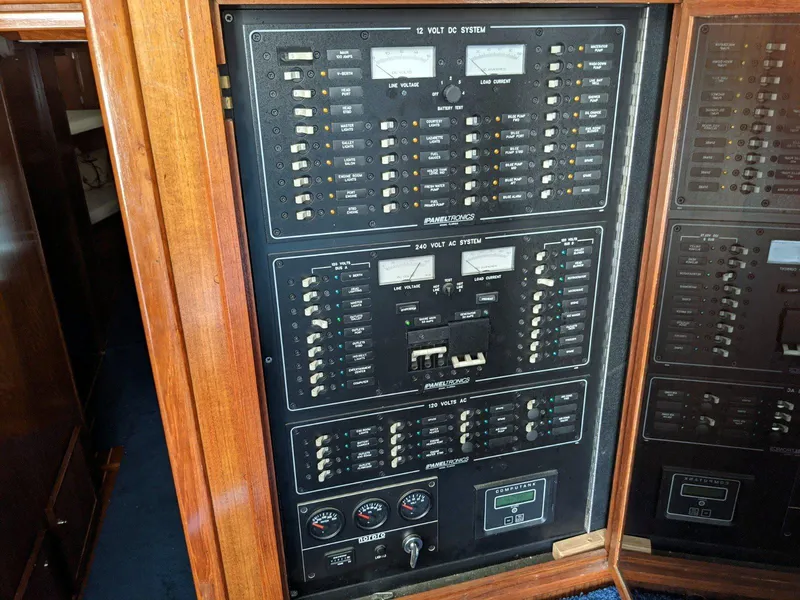 Slide: The Image of Electrical panel of a 1977 Hatteras 46 Convertible boat, featuring various switches and gauges. - 19