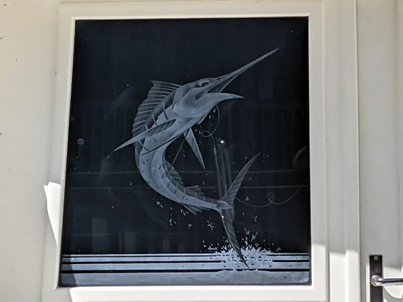 Slide: The Image of Etched marlin design on 1977 Hatteras 46 Convertible boat window. - 25
