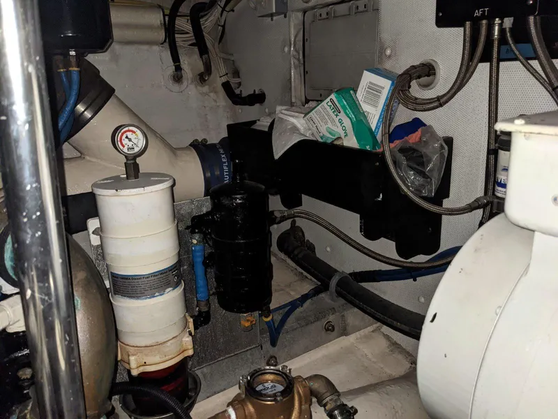 Slide: The Image of Engine room of 1977 Hatteras 46 Convertible with various mechanical components and wiring. - 33