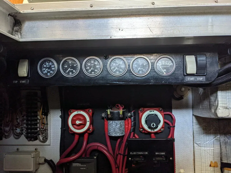 Slide: The Image of Control panel of a 1977 Hatteras 46 Convertible boat with gauges and switches. - 36