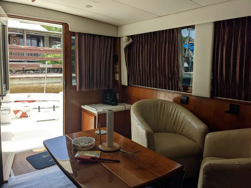 Slide: The Image of Interior of 1977 Hatteras 46 Convertible yacht with cozy seating and wooden table. - 12