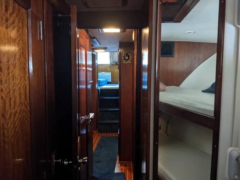 Slide: The Image of Interior of 1977 Hatteras 46 Convertible yacht with wood paneling and bunk beds. - 15
