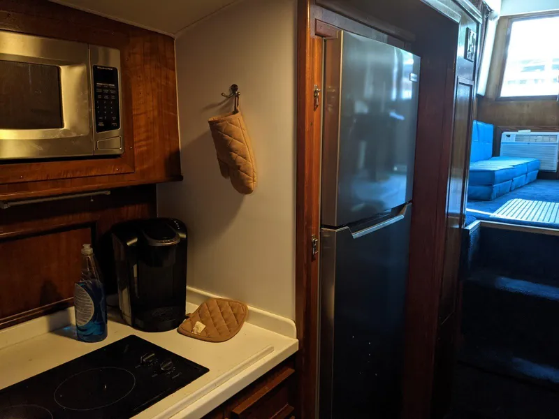 Slide: The Image of 1977 Hatteras 46 Convertible yacht kitchen with microwave, stove, and refrigerator. - 21