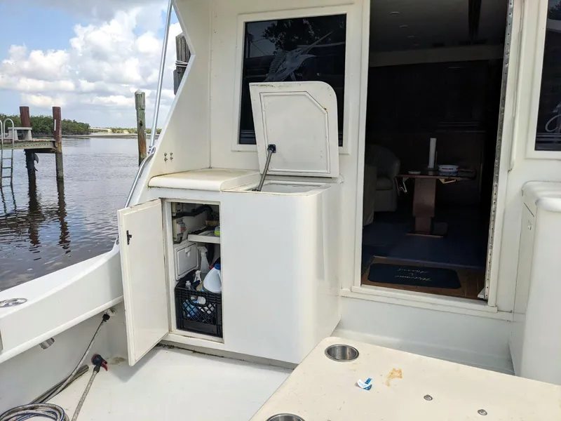 Slide: The Image of 1977 Hatteras 46 Convertible yacht with open storage and river view. - 29