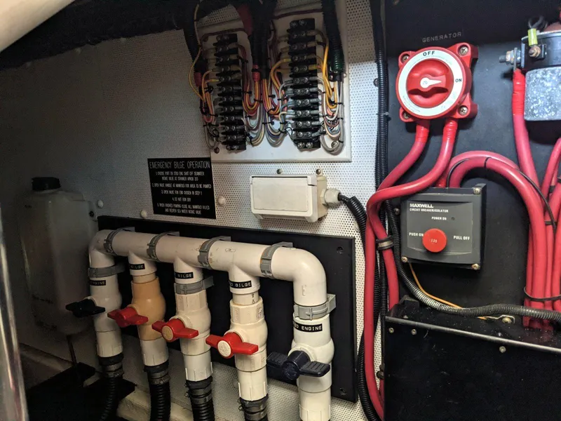 Slide: The Image of Electrical and plumbing systems inside a 1977 Hatteras 46 Convertible boat. - 35