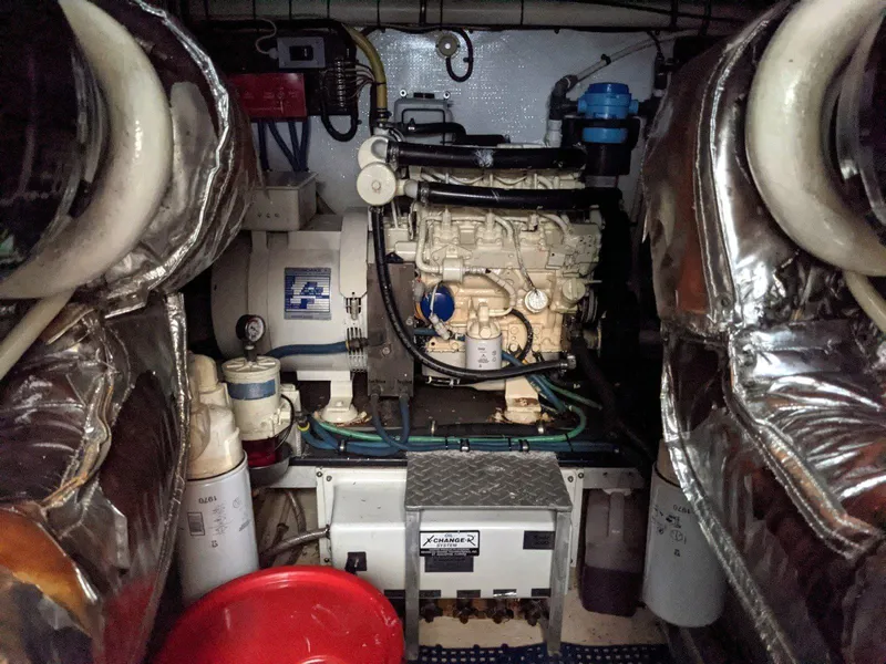 Slide: The Image of Engine room of a 1977 Hatteras 46 Convertible yacht, featuring mechanical components and equipment. - 38