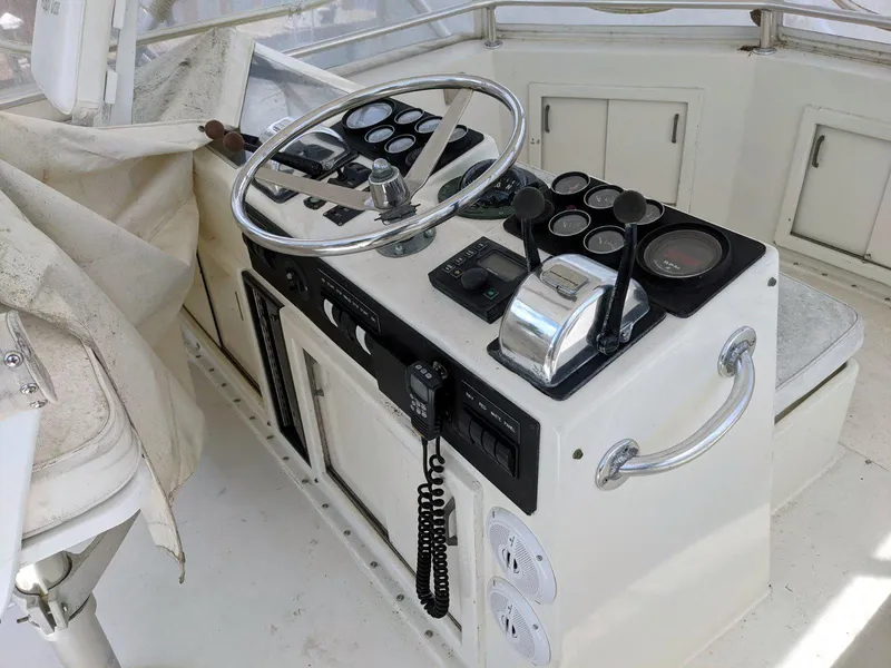 Slide: The Image of 1977 Hatteras 46 Convertible helm with steering wheel and control panel. - 4