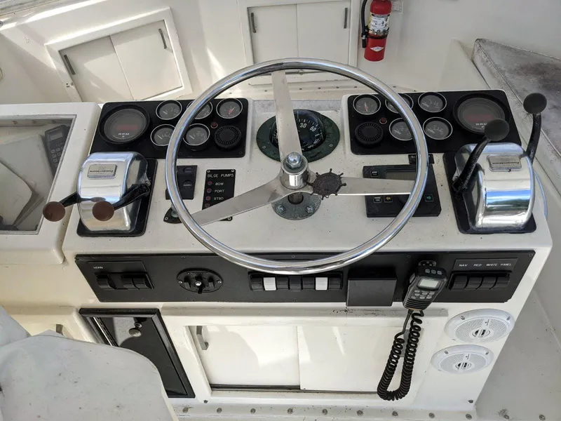 Slide: The Image of 1977 Hatteras 46 Convertible helm with steering wheel, gauges, and controls. - 5