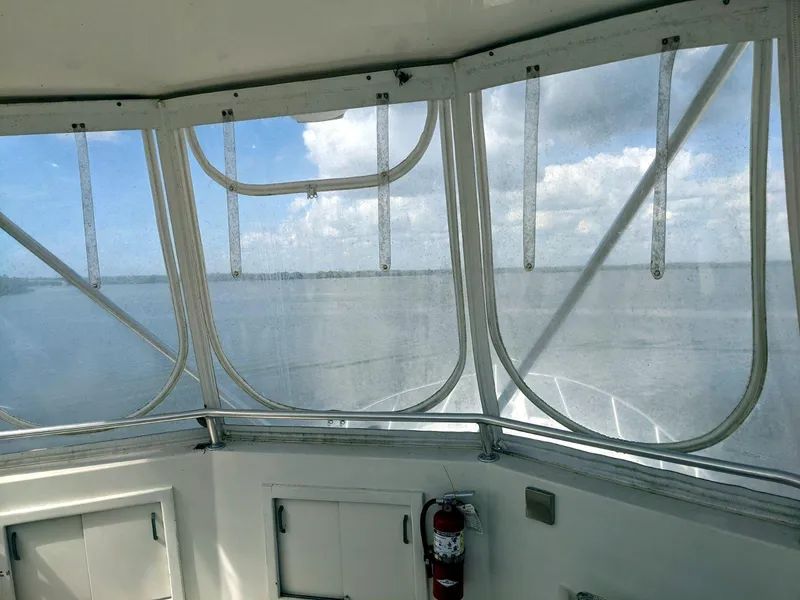 Slide: The Image of Interior view from a 1977 Hatteras 46 Convertible boat, overlooking calm waters. - 7
