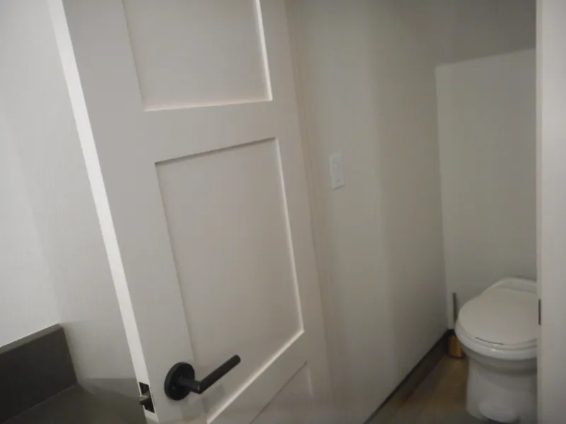 Slide: The Image of Small bathroom with white door and modern toilet, Adonia Melody Share #12, 2021. - 12