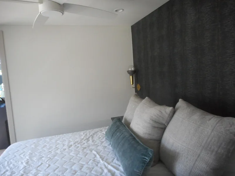 Slide: The Image of Modern bedroom with textured wall, cozy bedding, and ceiling fan in Adonia Melody Share #12, 2021. - 14