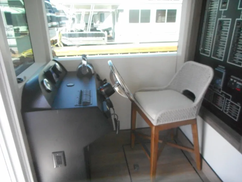 Slide: The Image of Pilot area of Adonia Melody Share #12 houseboat, featuring a steering wheel and chair, 2021 model. - 15