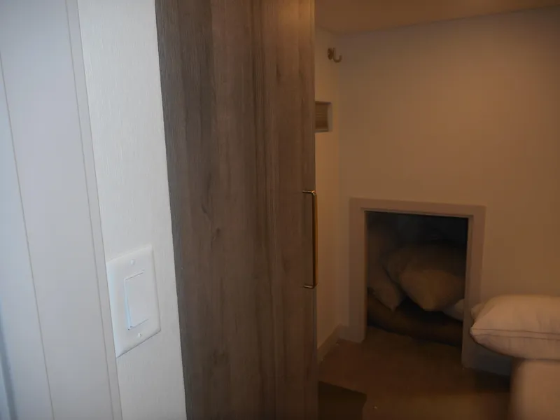 Slide: The Image of Cozy interior of Adonia Melody Share #12, featuring wooden accents and a small storage nook. - 29