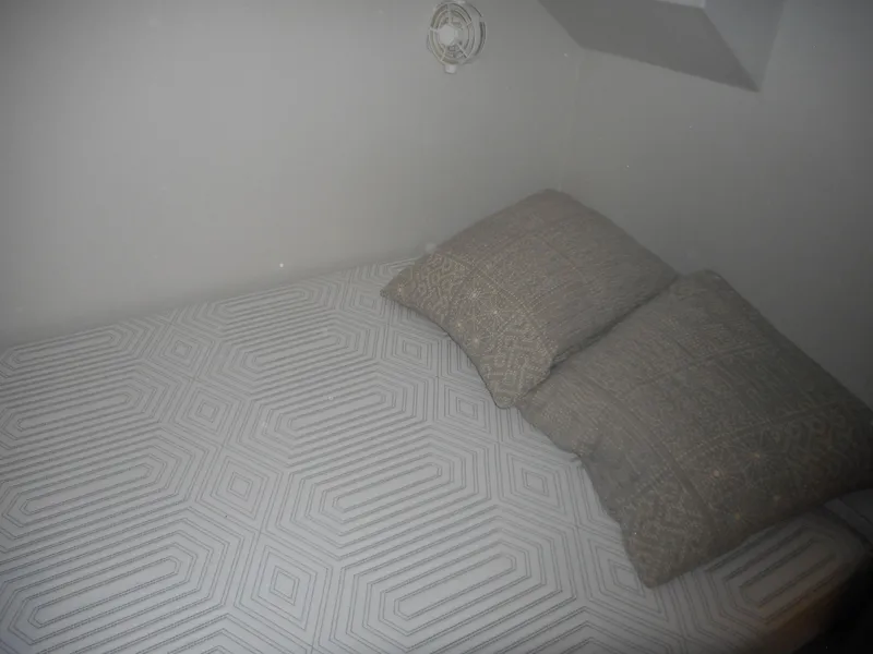 Slide: The Image of Cozy bed with geometric-patterned bedding and pillows in a minimalist room, Adonia Melody Share #12. - 34