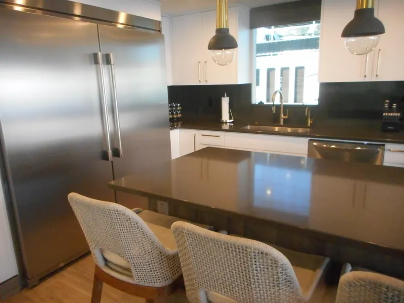 Slide: The Image of Modern kitchen with stainless steel appliances, sleek countertops, and stylish lighting fixtures. - 37