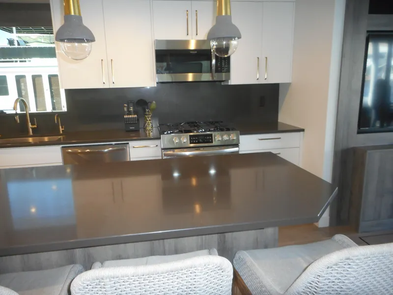 Slide: The Image of Modern kitchen with sleek countertops, stainless steel appliances, and pendant lighting in Adonia Melody Share #12. - 38