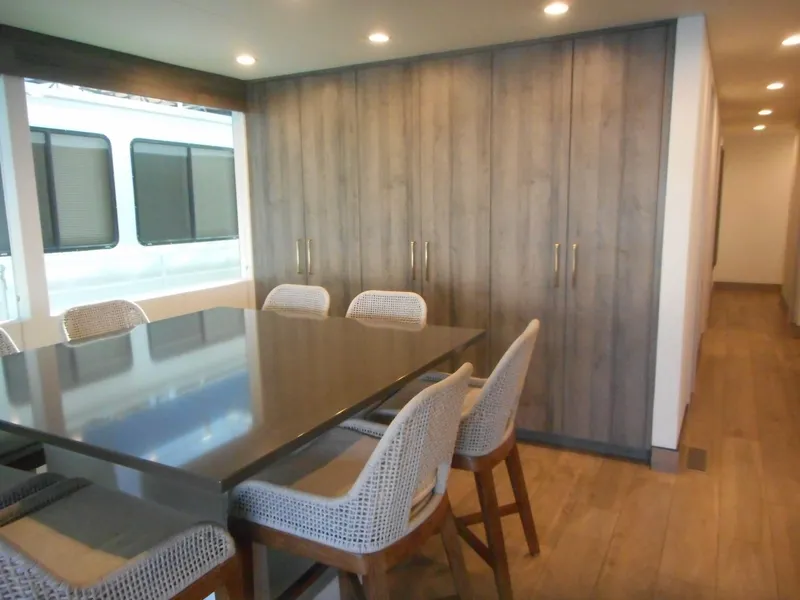 Slide: The Image of Modern dining area in Adonia Melody Share #12, 2021, with sleek table and wooden cabinetry. - 39