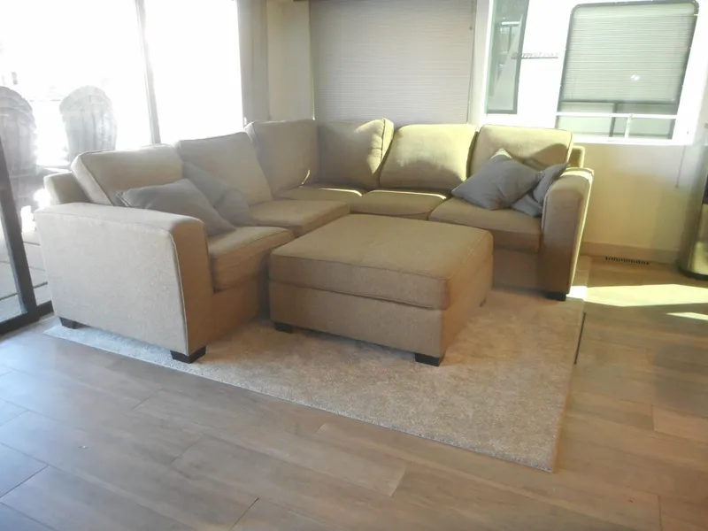Slide: The Image of Cozy beige sectional sofa with ottoman in a sunlit living room, Adonia Melody Share #12, 2021. - 41