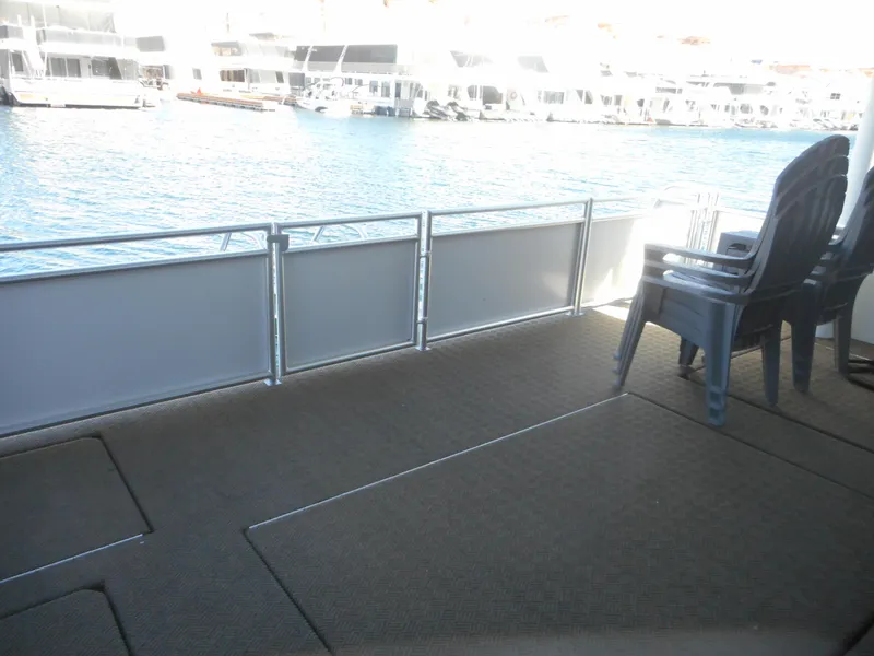 Slide: The Image of Deck view from Adonia Melody Share #12 houseboat, 2021, overlooking marina with stacked chairs. - 44