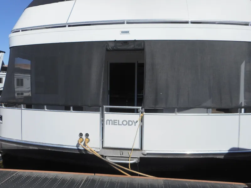 Slide: The Image of Houseboat "Melody" by Adonia, 2021 model, docked with visible mooring lines. - 5
