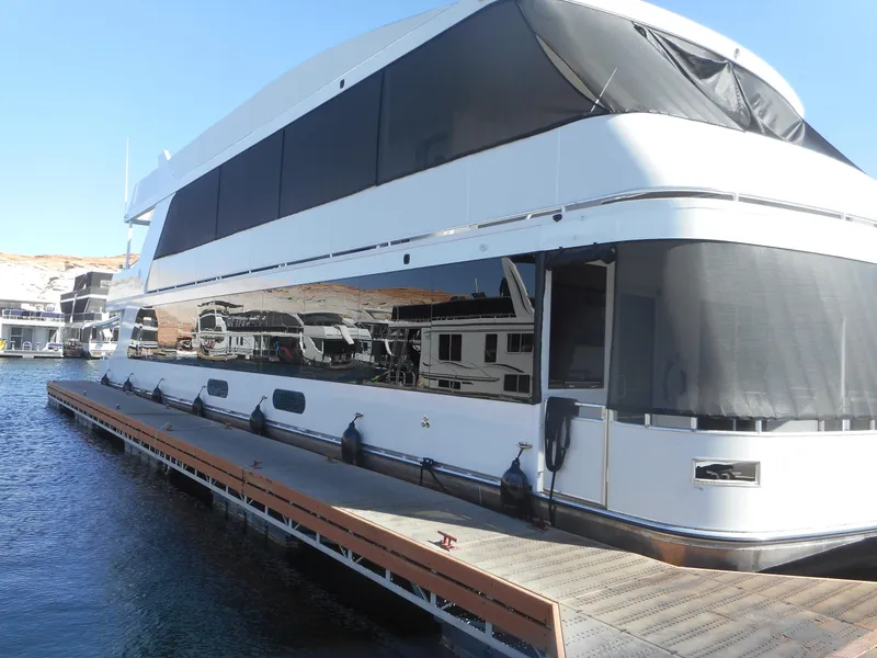 Slide: The Image of Luxury Adonia Melody Share #12 houseboat docked, 2021 model, with sleek design and tinted windows. - 6