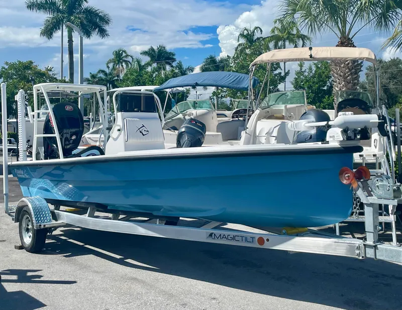 Slide: The Image of 2025 Piranha Magro P180 boat on trailer, parked outdoors under palm trees. - 0