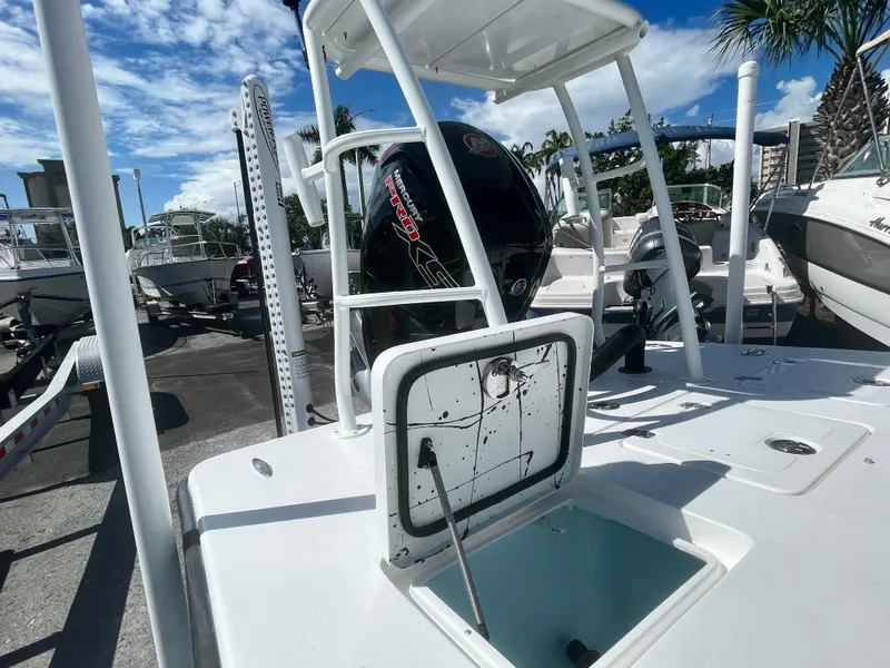 Slide: The Image of 2025 Piranha Magro P180 boat with open hatch, outboard motor, and clear sky background. - 10