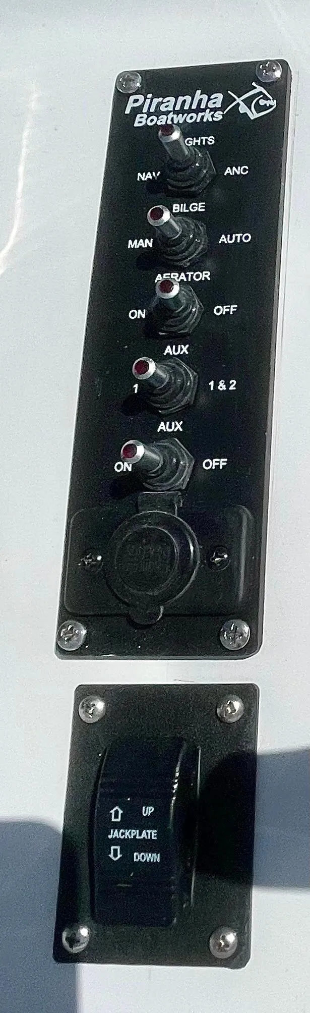 Slide: The Image of Control panel of Piranha Magro P180 boat, featuring switches and dials, 2025 model. - 13