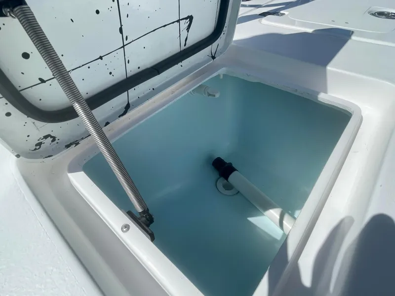 Slide: The Image of Open storage compartment on 2025 Piranha Magro P180 boat, featuring hydraulic support. - 14