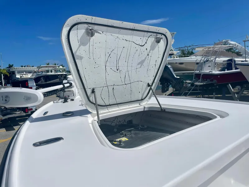 Slide: The Image of Open hatch on 2025 Piranha Magro P180 boat, docked under clear blue sky. - 19