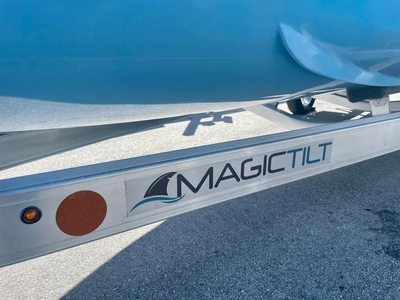 Slide: The Image of Trailer with "Magic Tilt" logo under Piranha Magro P180 boat, 2025 model. - 23