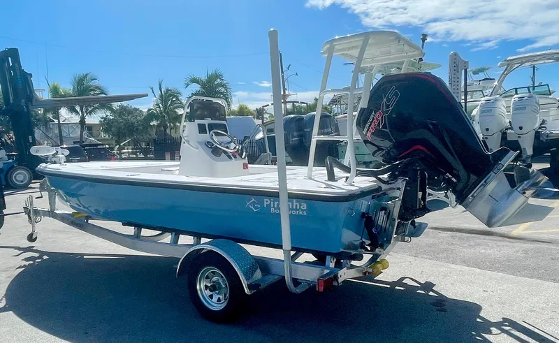 Slide: The Image of 2025 Piranha Magro P180 boat on trailer, parked outdoors under clear sky. - 26