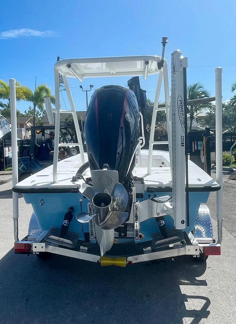 Slide: The Image of 2025 Piranha Magro P180 boat with outboard motor, parked outdoors under clear sky. - 27