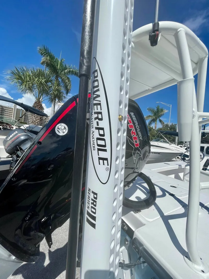 Slide: The Image of Power-Pole Pro II on Piranha Magro P180 boat, 2025 model, with palm trees in the background. - 4