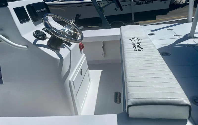 Slide: The Image of 2025 Piranha Magro P180 boat interior with steering wheel and cushioned seating. - 8